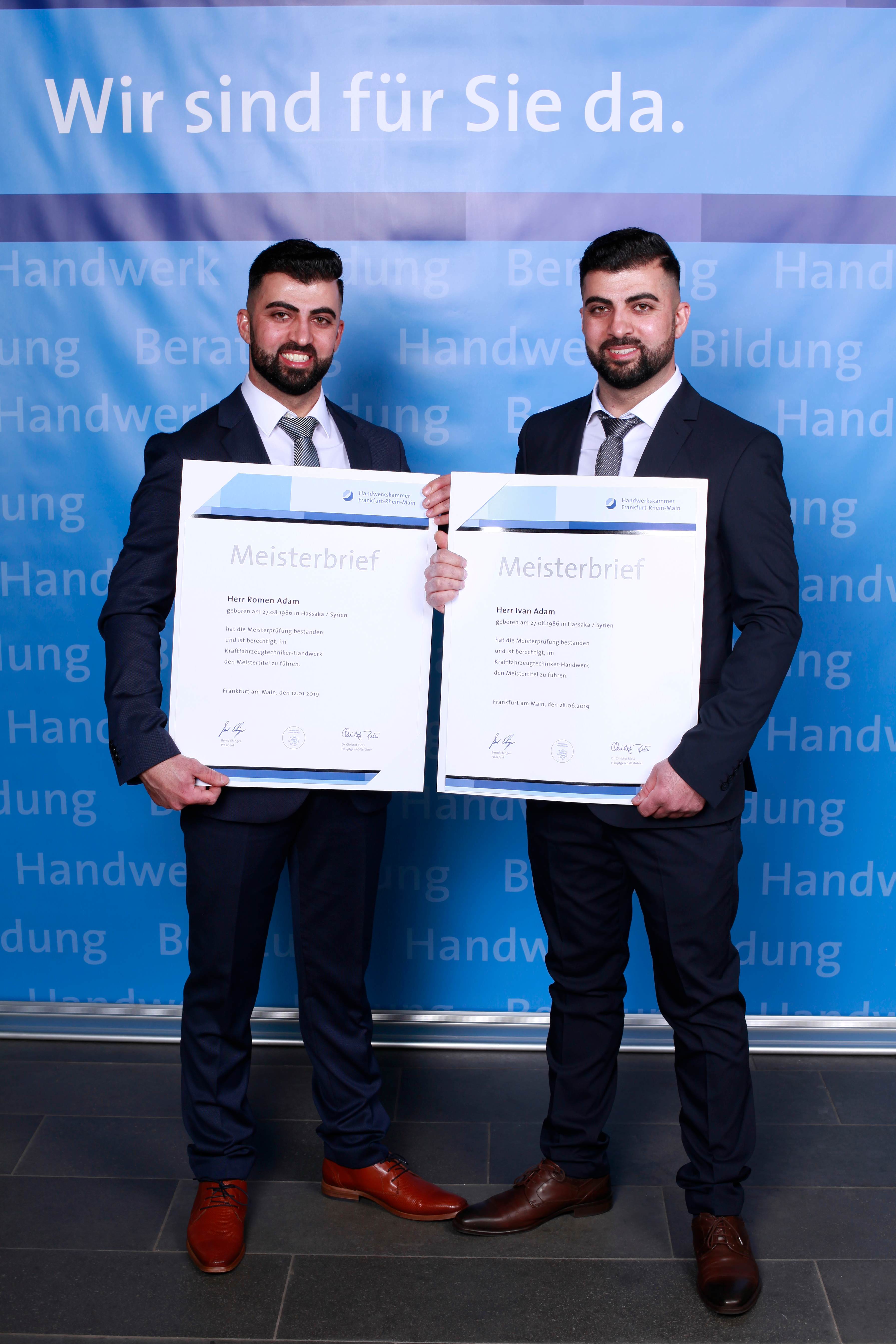 Adam's AutoHaus founders Ivan and Romen Adam celebrating Master Craftsman certification at Handwerkskammer Frankfurt-Rhein-Main